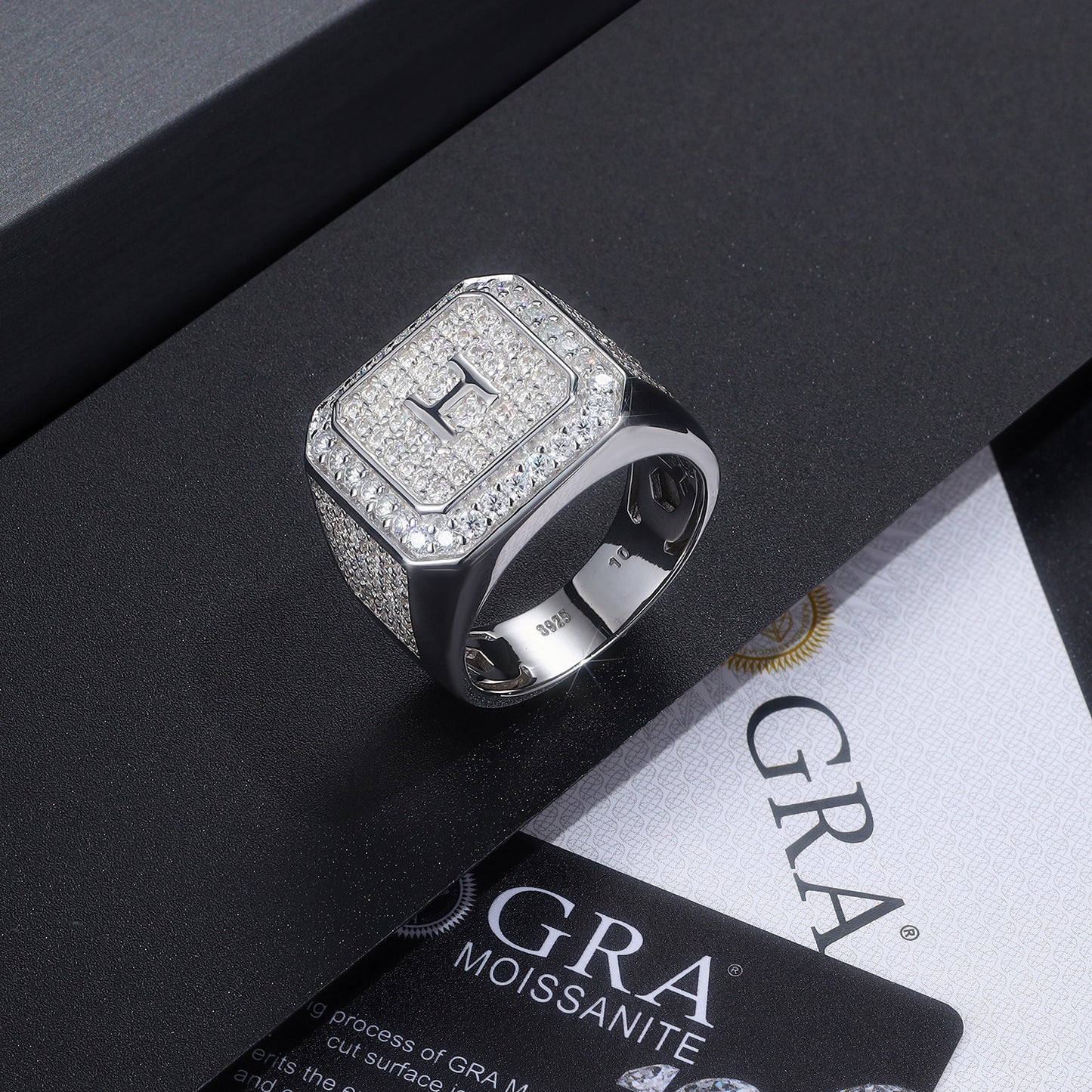 Silver ring with gemstones on a black and white background