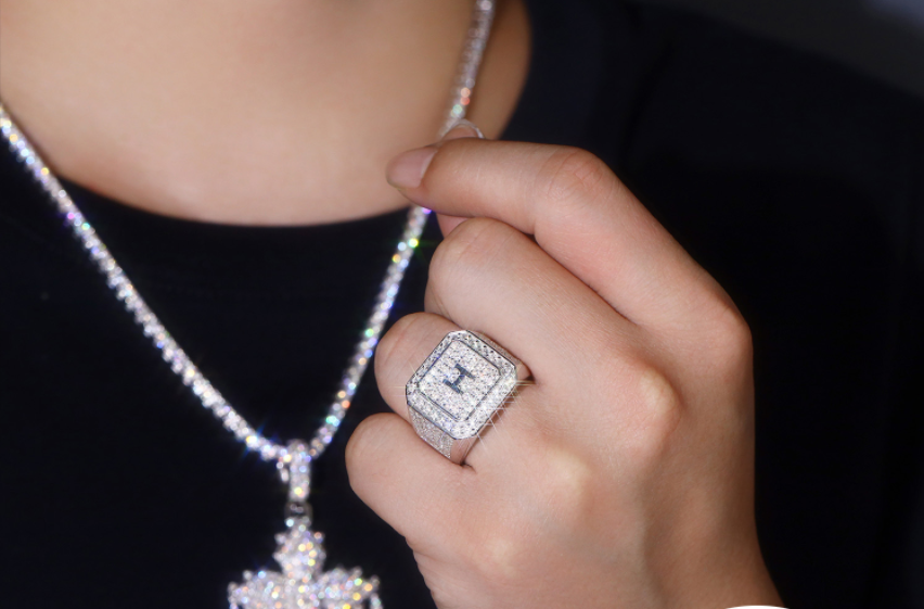Close-up of a hand wearing a diamond ring with a blurred background