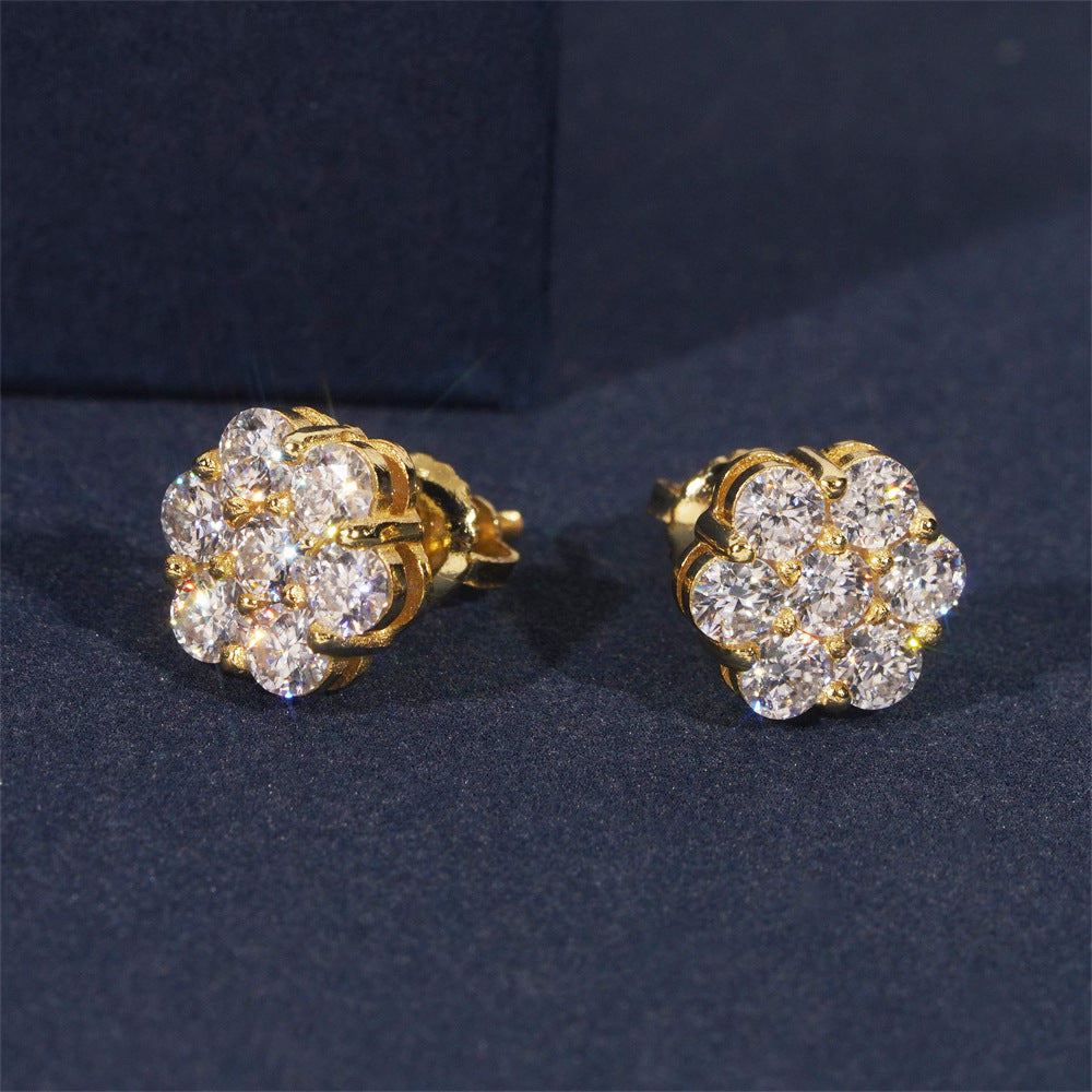 Gold and diamond earrings on a dark blue background