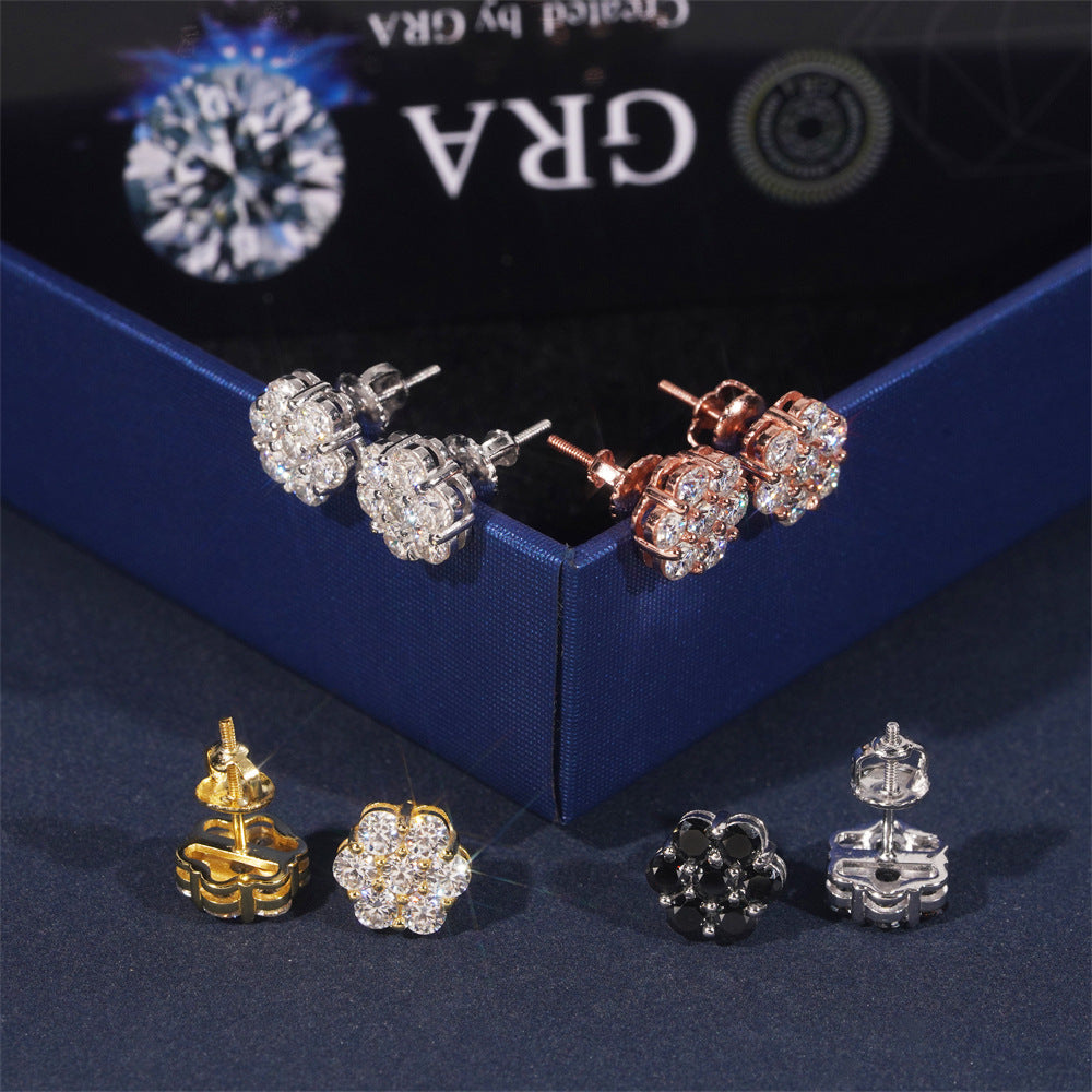 Set of earrings on a dark surface with 'Gra' branding in the background.