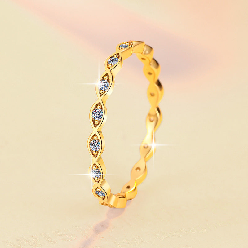 Gold ring with small diamonds on a gradient background