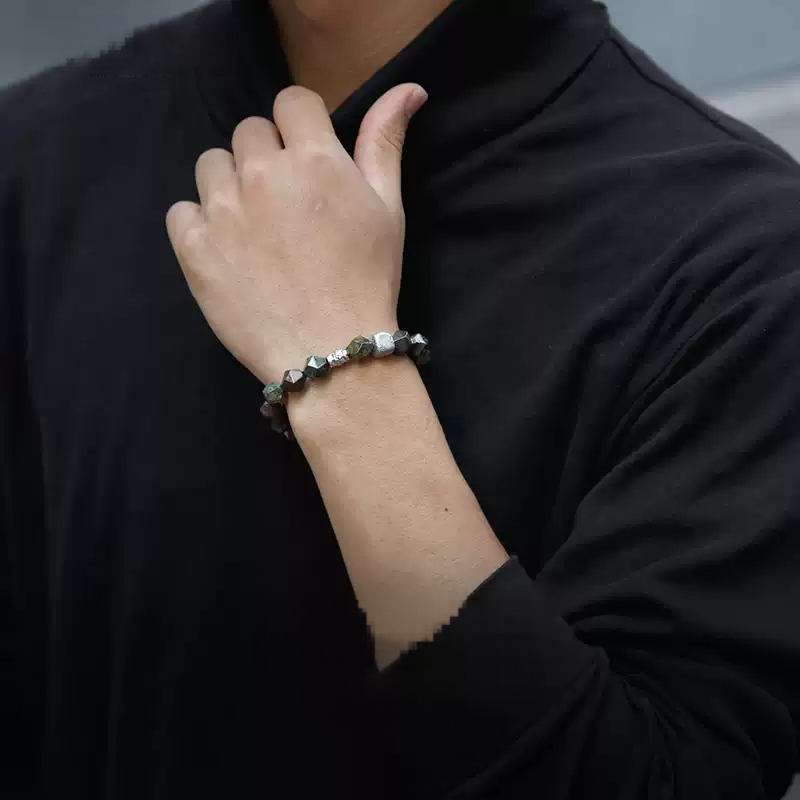 Person wearing a bracelet on a blurred background