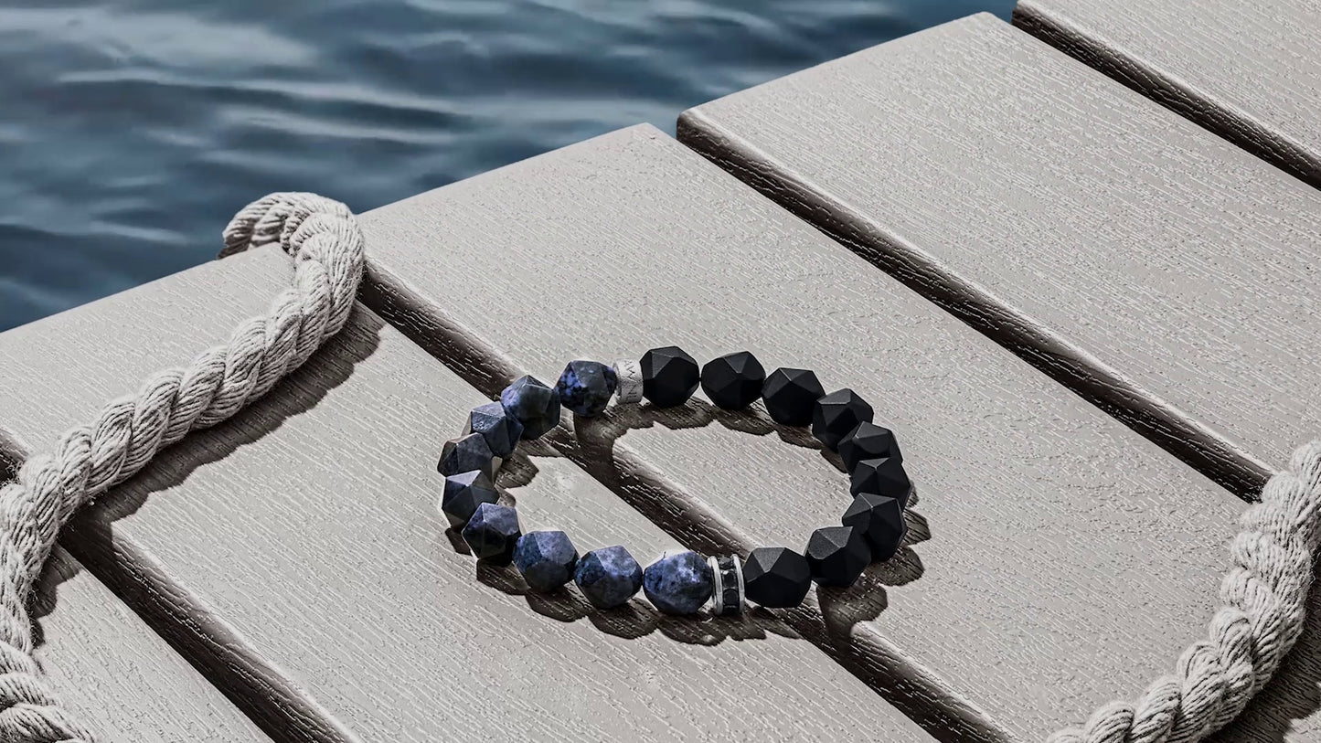 Bracelet with blue stones on a wooden surface near water