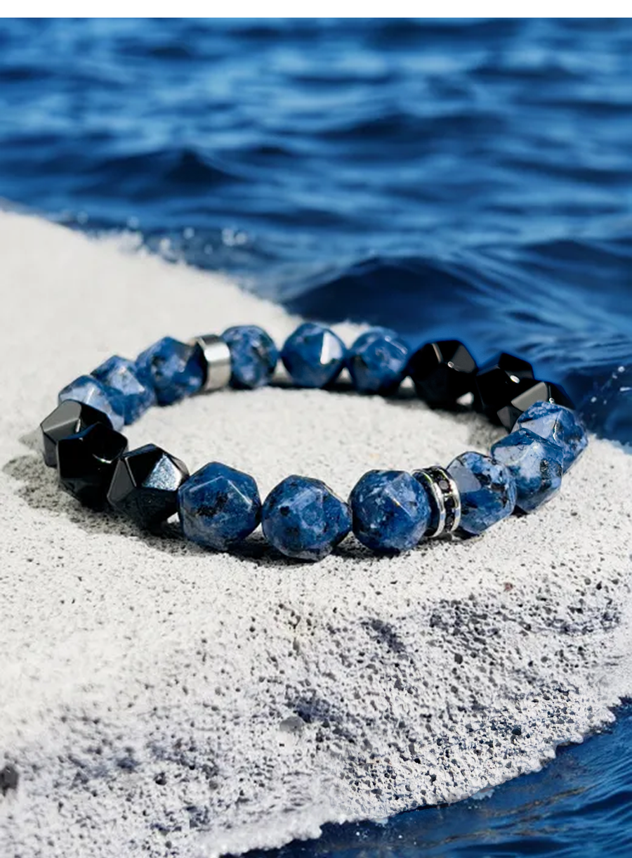 Blue beaded bracelet on a rock with water in the background