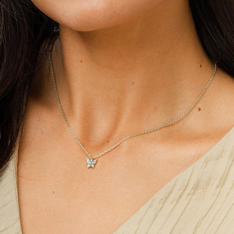 Woman Wearing Minimalist Silver Butterfly Necklace