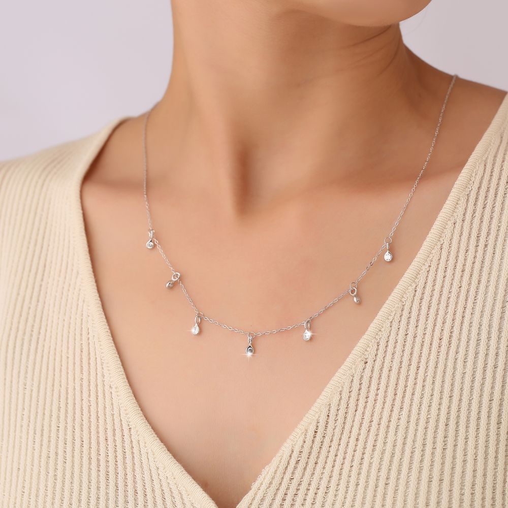 “Model wearing geometric teardrop silver zircon necklace”