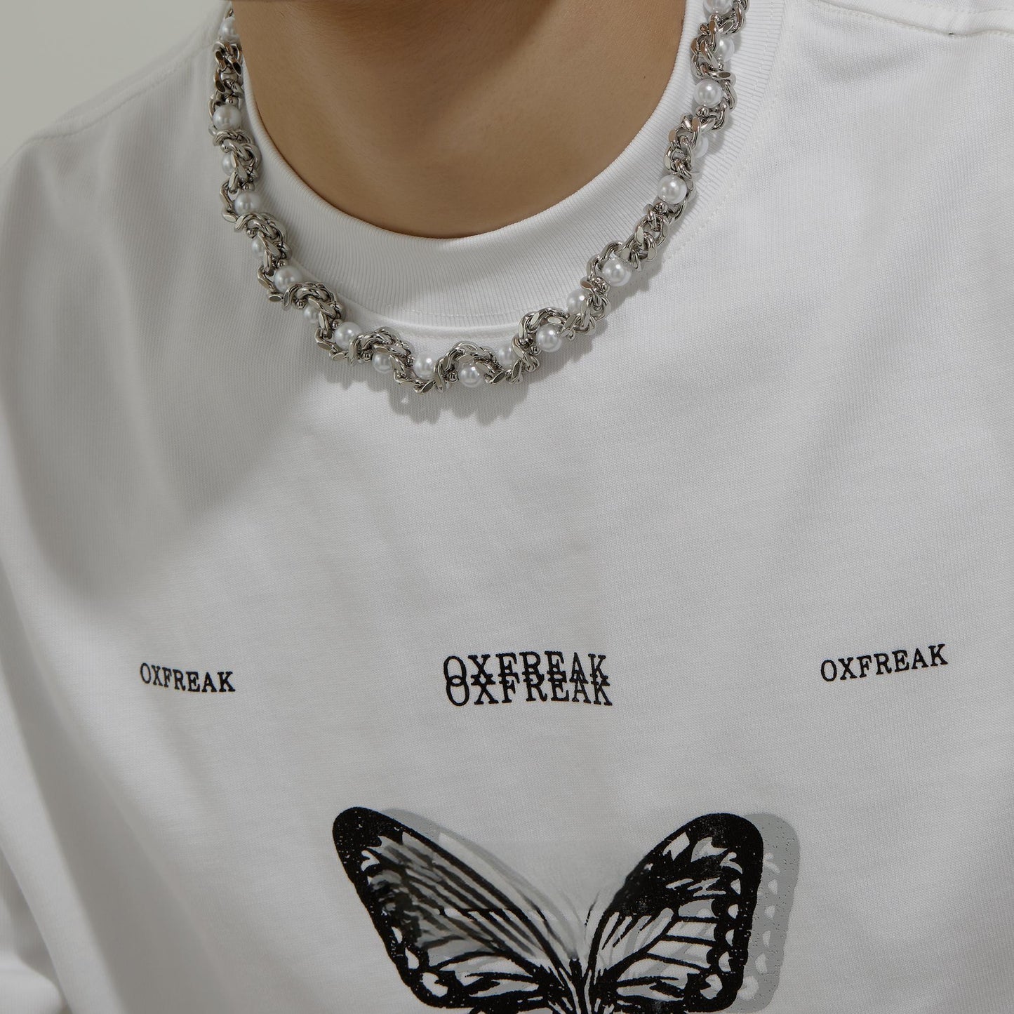 “streetwear men’s silver snake choker styled with cold aesthetic outfit”