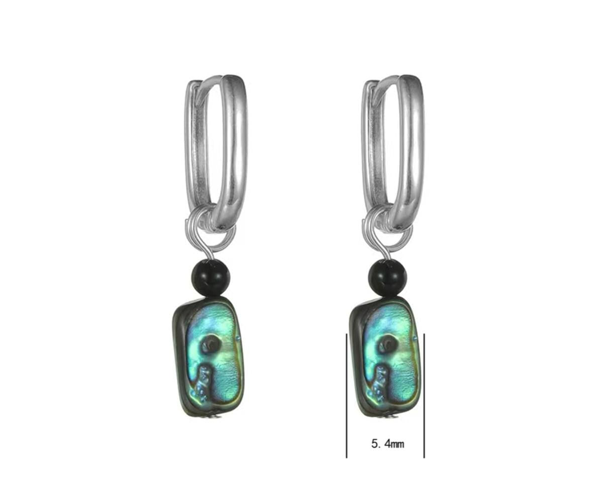 Pair of hoop earrings with green shell and black bead accents on a white background