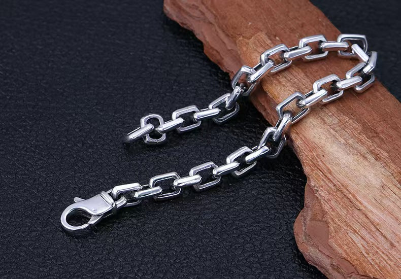 Silver chain with clasp on a dark background