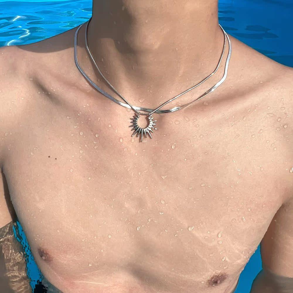 “men’s minimalist silver sun god necklace styled with cold aesthetic outfit”