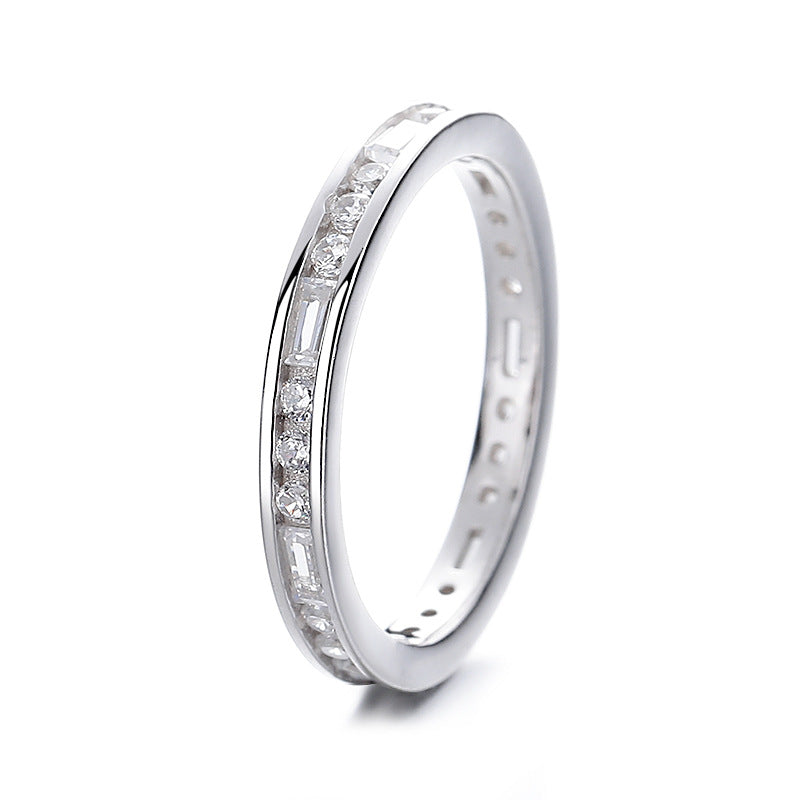 Silver ring with embedded diamonds on a white background