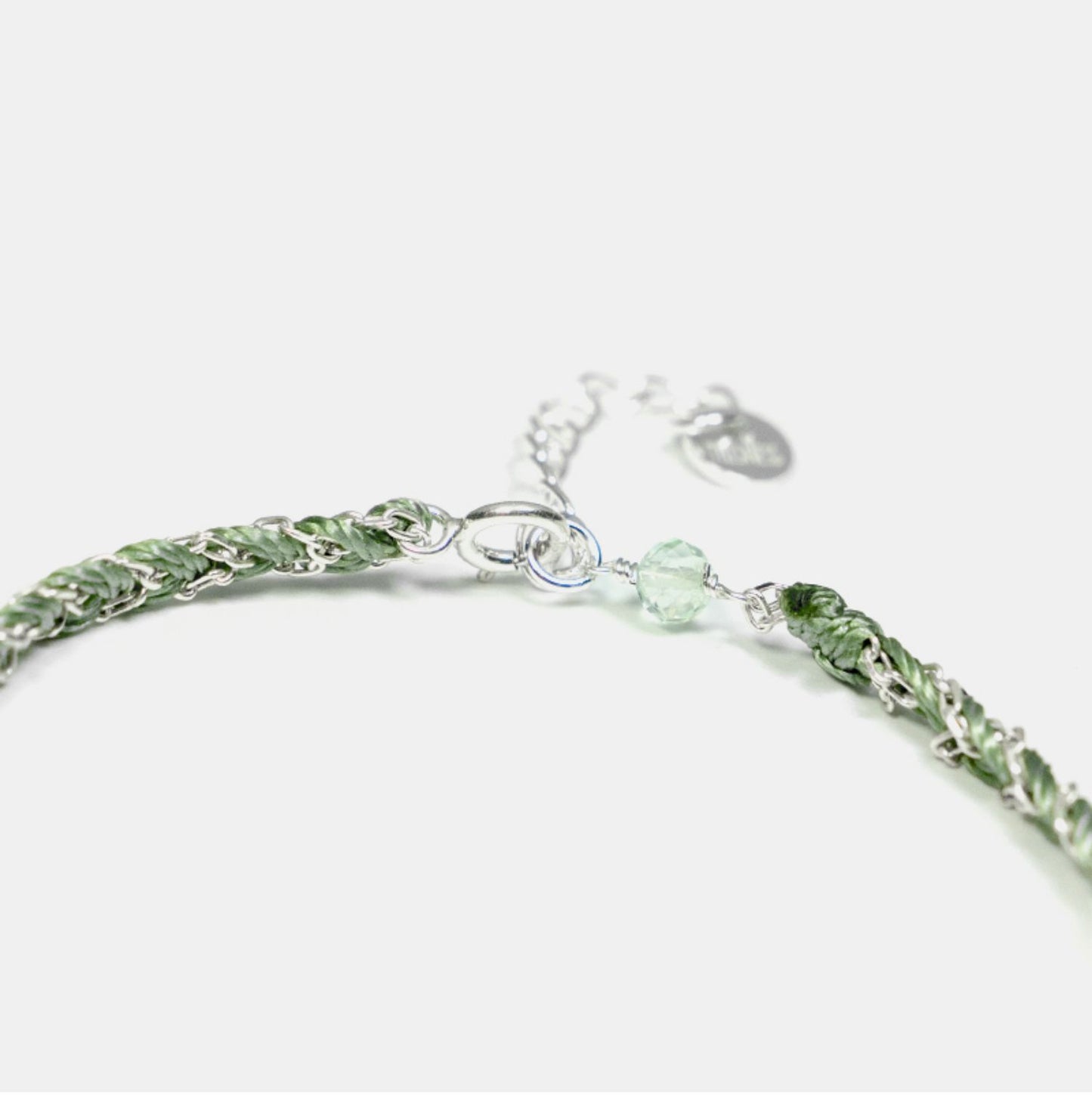 Green beaded bracelet on a white background