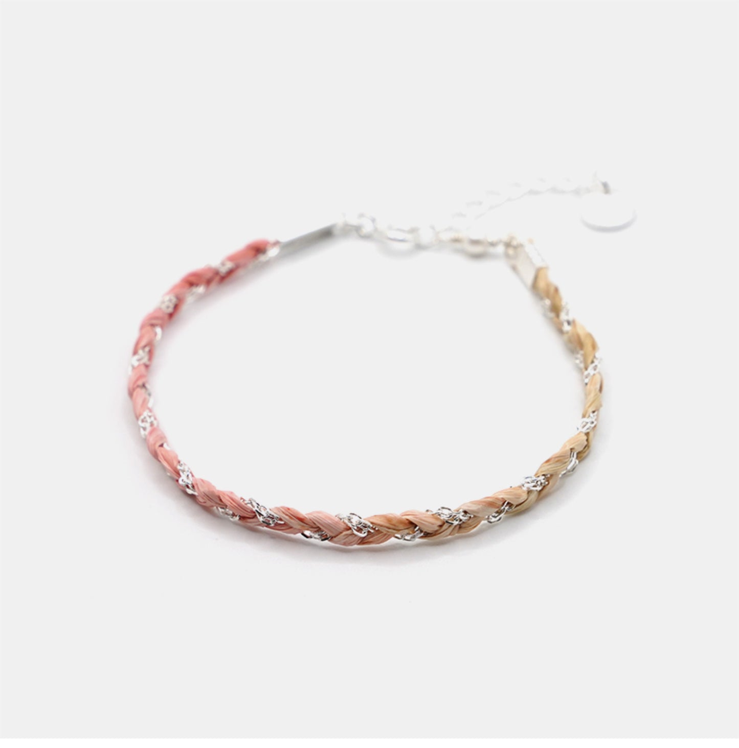 Braided bracelet with pink and beige strands on a white background
