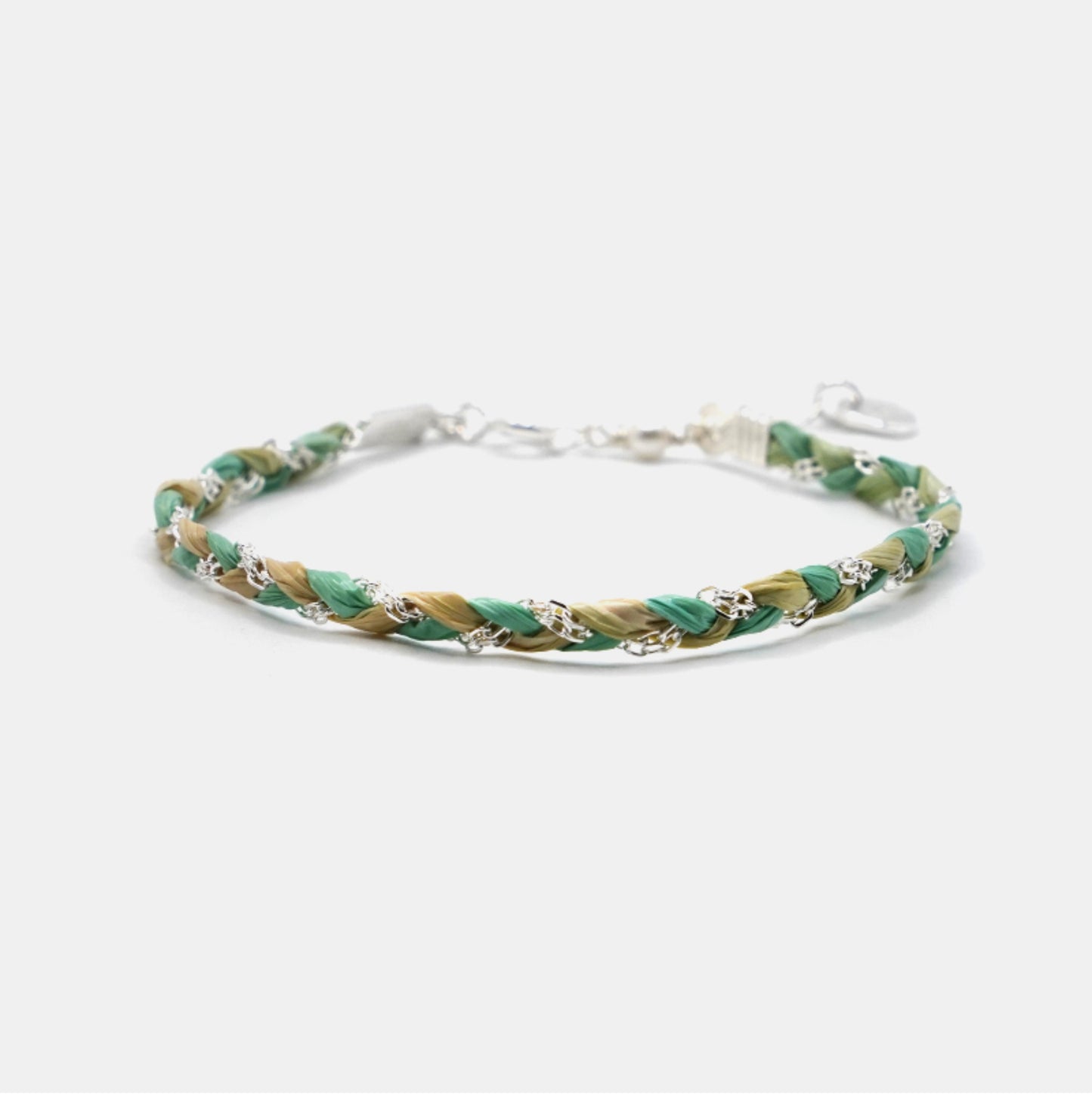 Braided bracelet with green and gold tones on a white background