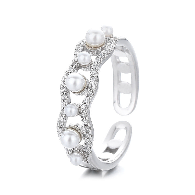 Silver ring with pearls on a white background