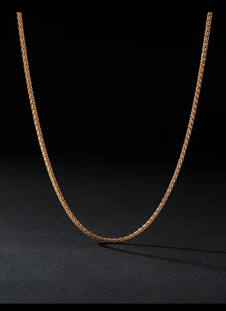 Gold chain necklace on a black background