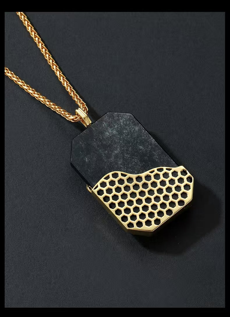 Necklace with a black pendant featuring a gold honeycomb pattern on a dark background