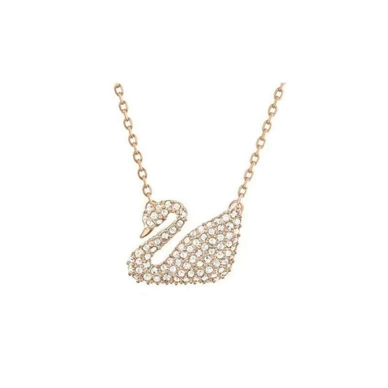 Rose gold swan-shaped necklace on a white background