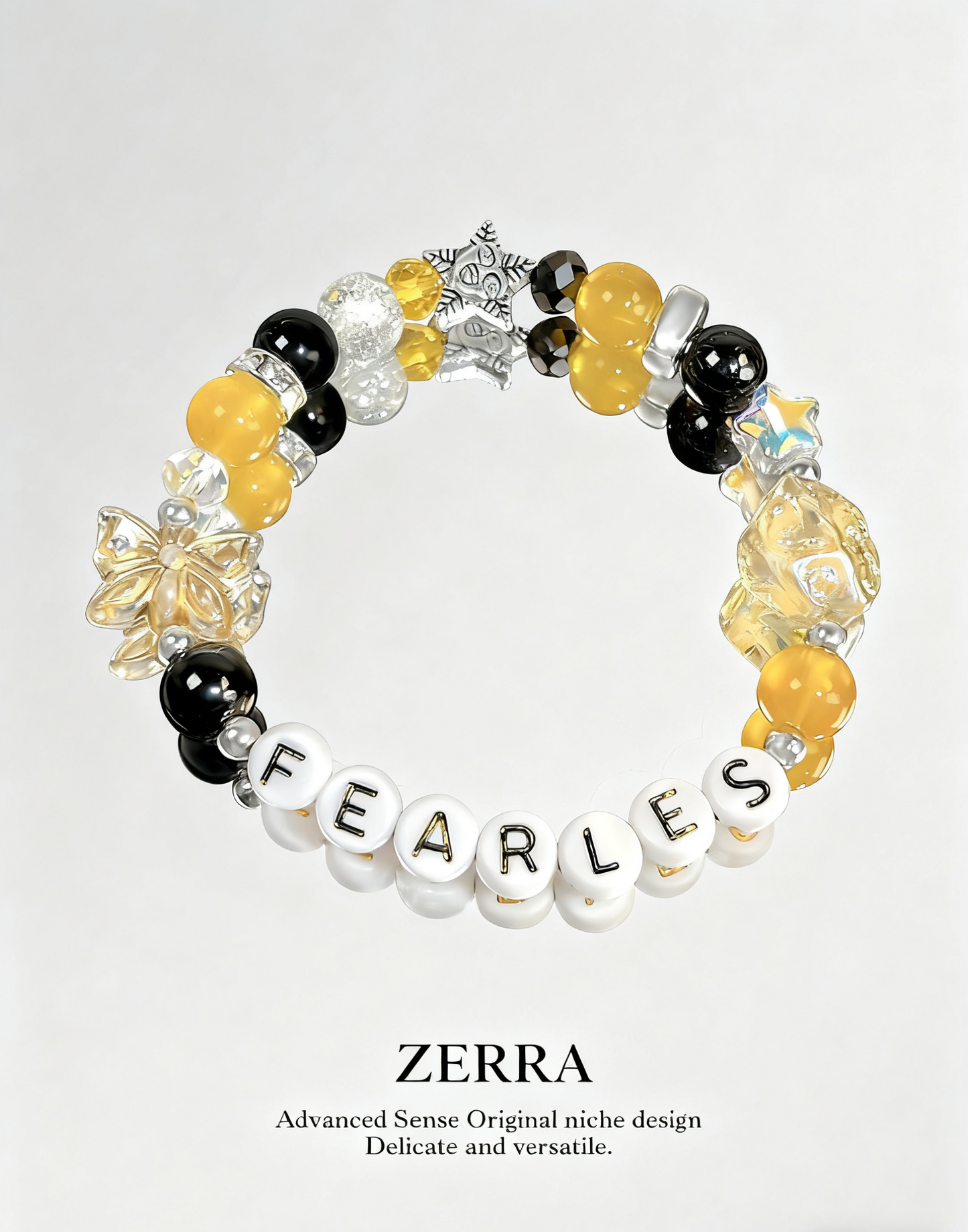 Bracelet with yellow, black, and white beads spelling 'FEARLES' on a light gray background.