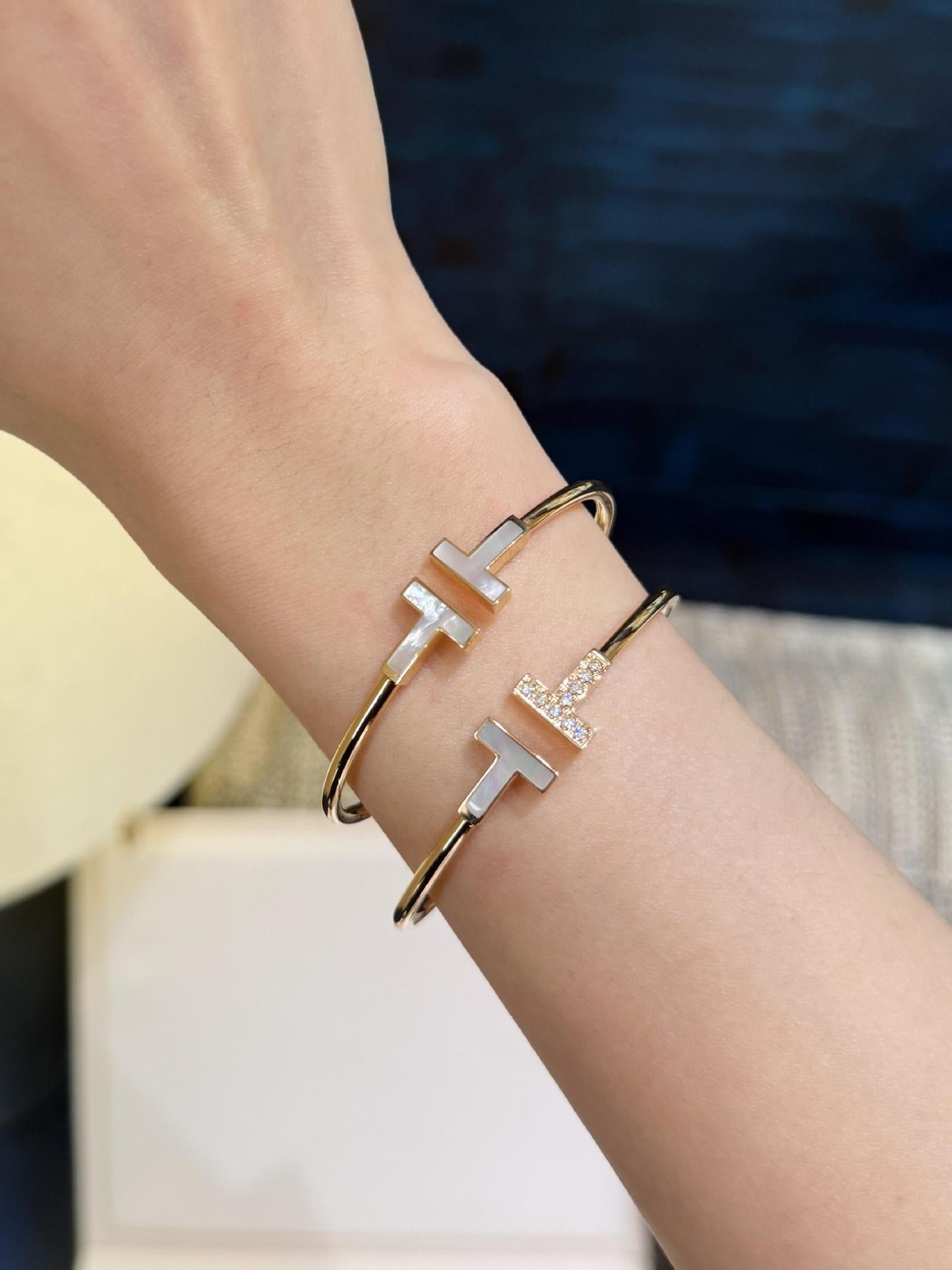 Gold and silver bracelet on a wrist with a blurred background