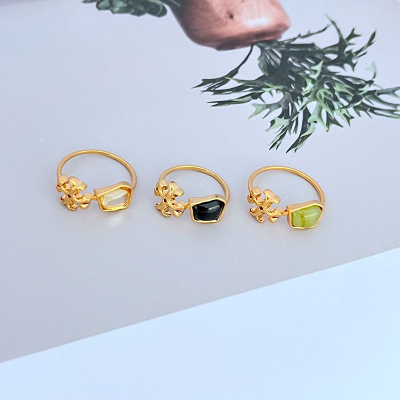 The ring placed next to other minimalist jewelry items on a simple tray, conveying a theme of curated, essential style.