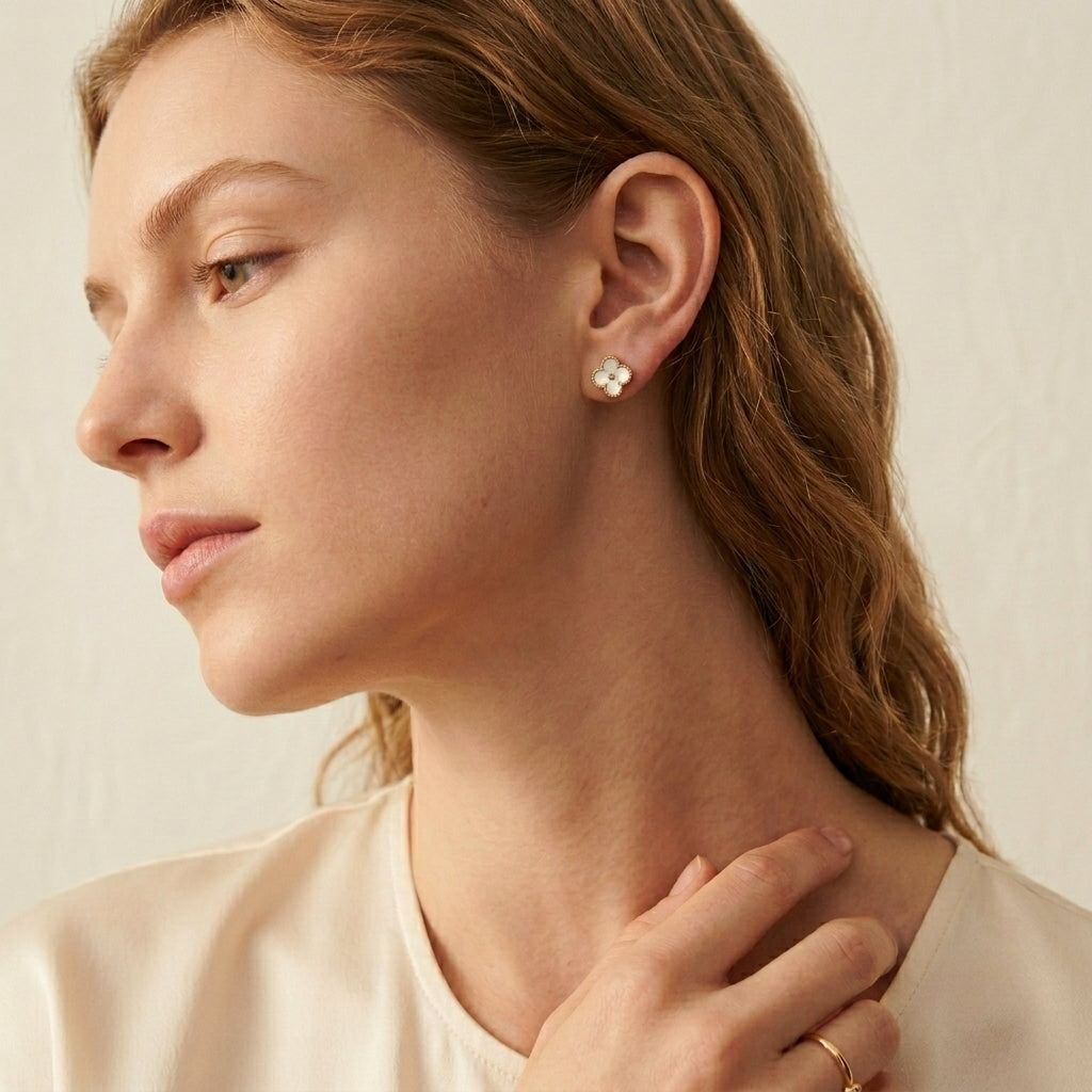 Close-up of a woman wearing earrings with a neutral background