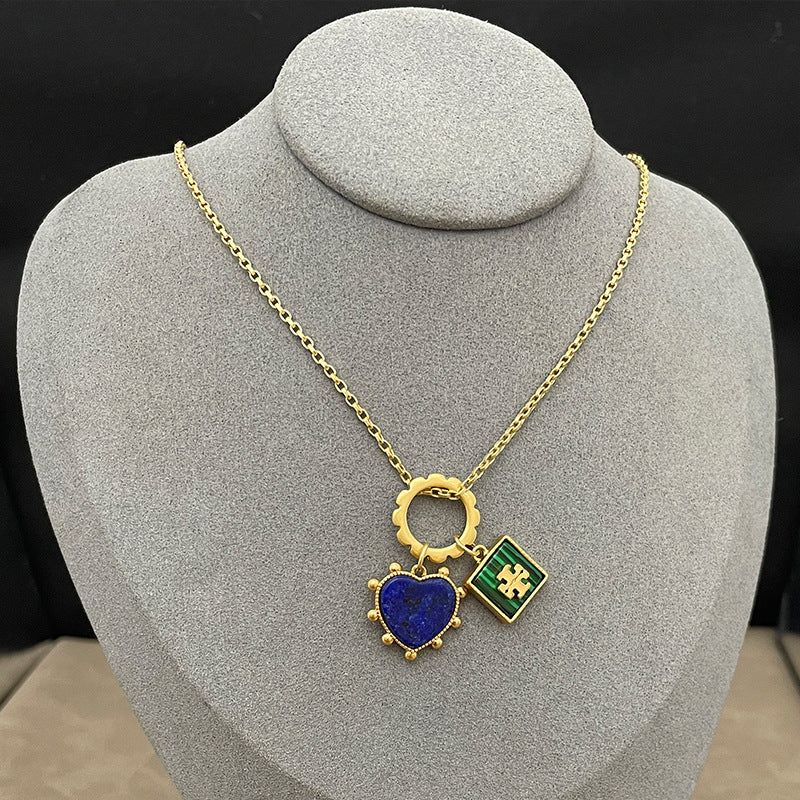 Close-up focused on the heart and square charms side-by-side, highlighting the iridescent play of color in the mother of pearl and the gold borders.