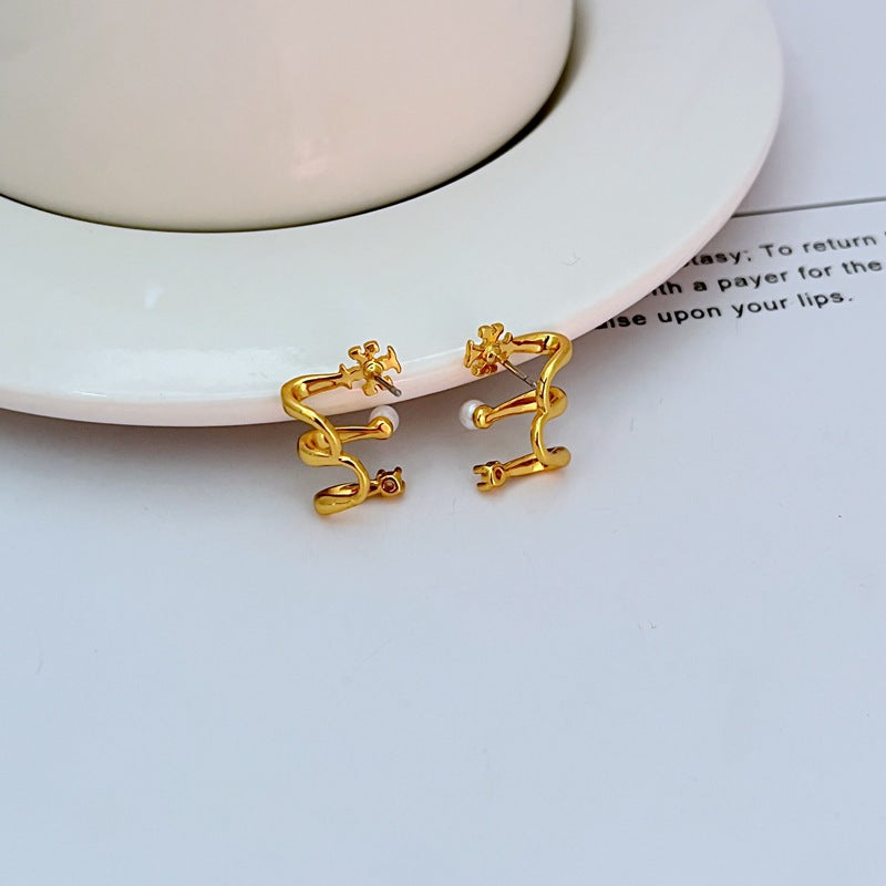 A modern, stylish woman with a sleek hairstyle (like a low bun or tucked-behind-the-ears cut) showcasing the earrings. She is in a contemporary setting, smiling, highlighting the earrings' fashion-forward vibe.