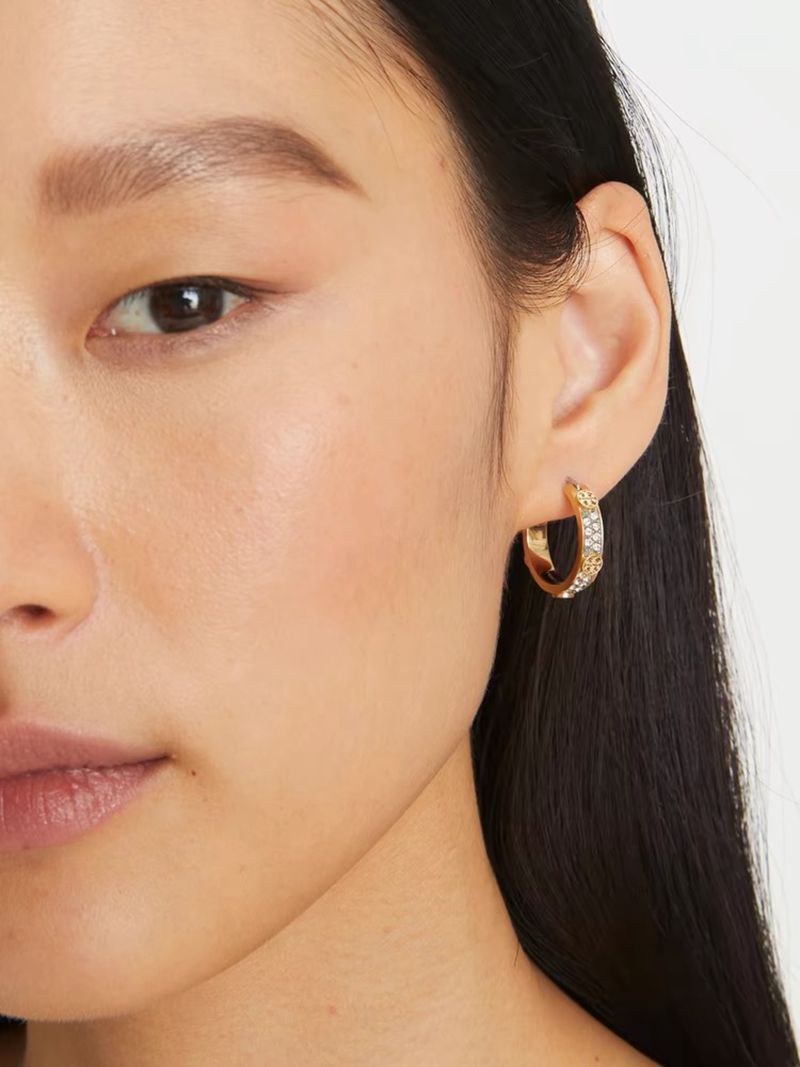 Earrings worn on a model, showing how the stud sits comfortably on the earlobe while the hoop drapes elegantl