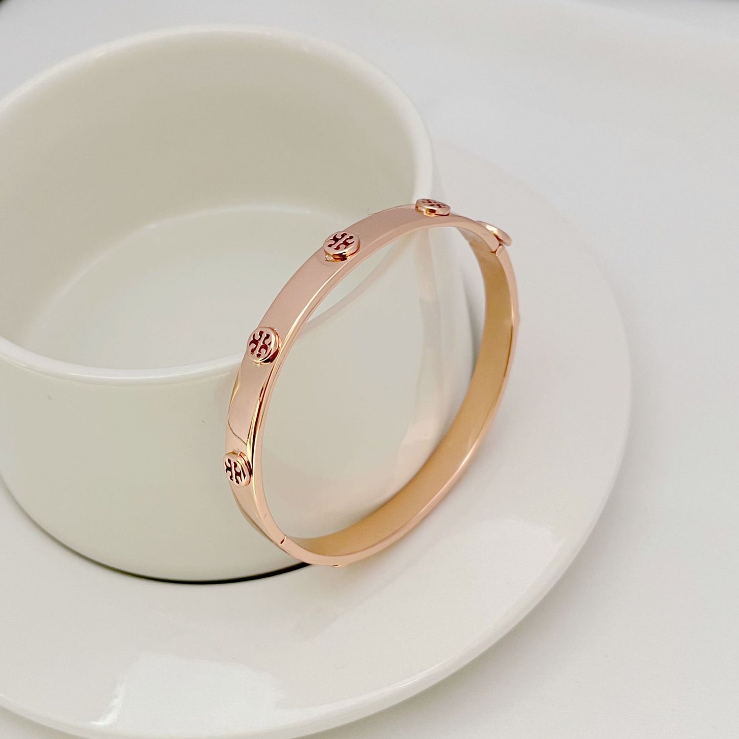 Bracelet displayed open on a dark velvet background, emphasizing the continuous line of pave crystals and sleek metal band.