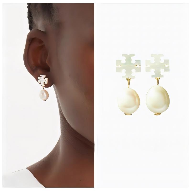 A woman with an elegant, serene demeanor, perhaps at a gallery event or outdoor dinner. Her hair is styled away from her face, showing the earrings' graceful movement as she turns her head slightly.