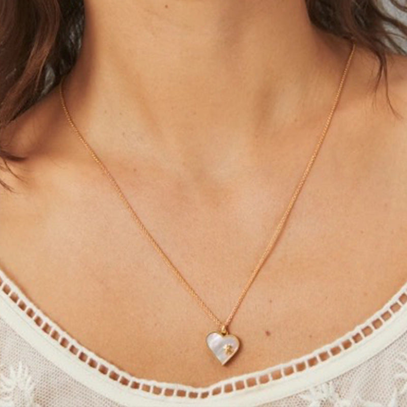 The necklace and earrings worn by a model, showing how the coordinated set creates a polished, harmonious look.