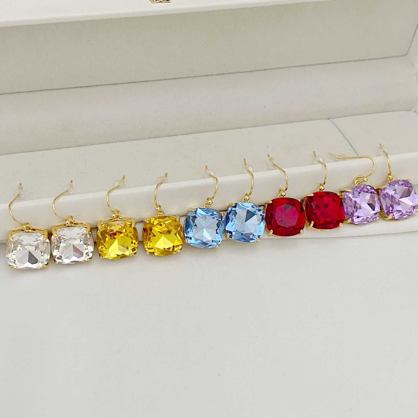 High-definition shot of the pair of earrings laid flat on pure white background, arranged symmetrically.