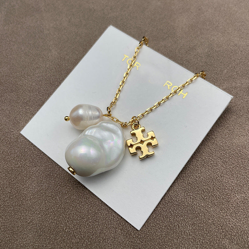 Close-up focusing on the pearl and its setting, showcasing the pearl’s smooth surface and the metal’s polished finish.