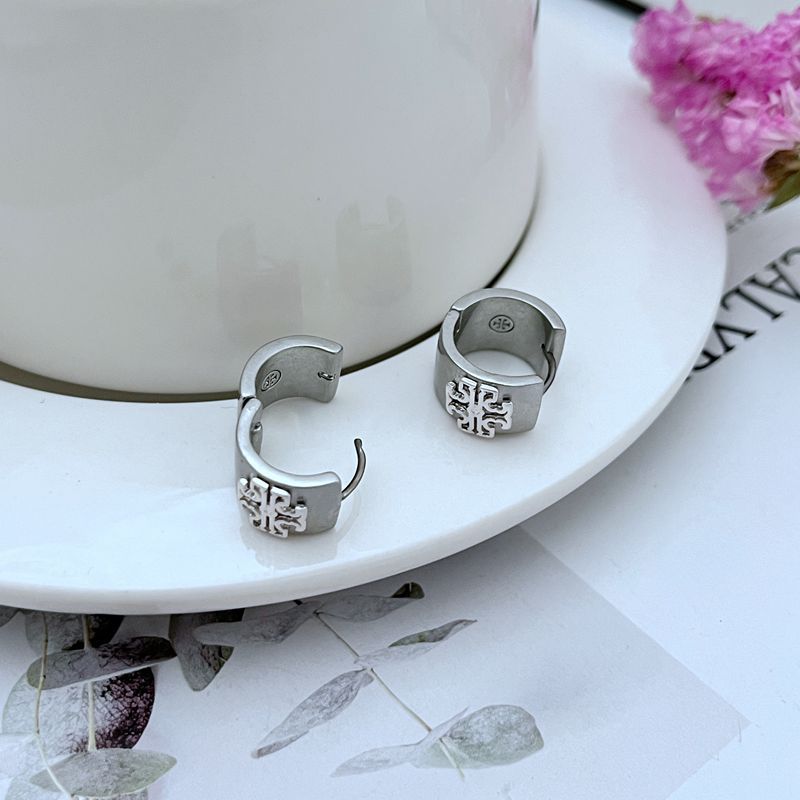 Earrings placed next to a common small object (e.g., a coin or pencil tip) to visually emphasize their 1.5cm size.