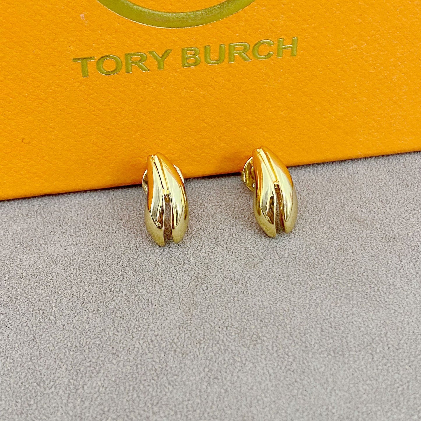 High-definition shot of the pair of earrings laid flat on pure white background, arranged symmetrically.