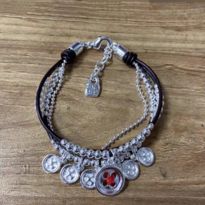 Silver bracelet on neutral background showing textured surface. Alt: “UNO de 50 Sterling Silver-Plated Bracelet – Textured Silver Cuff.”
