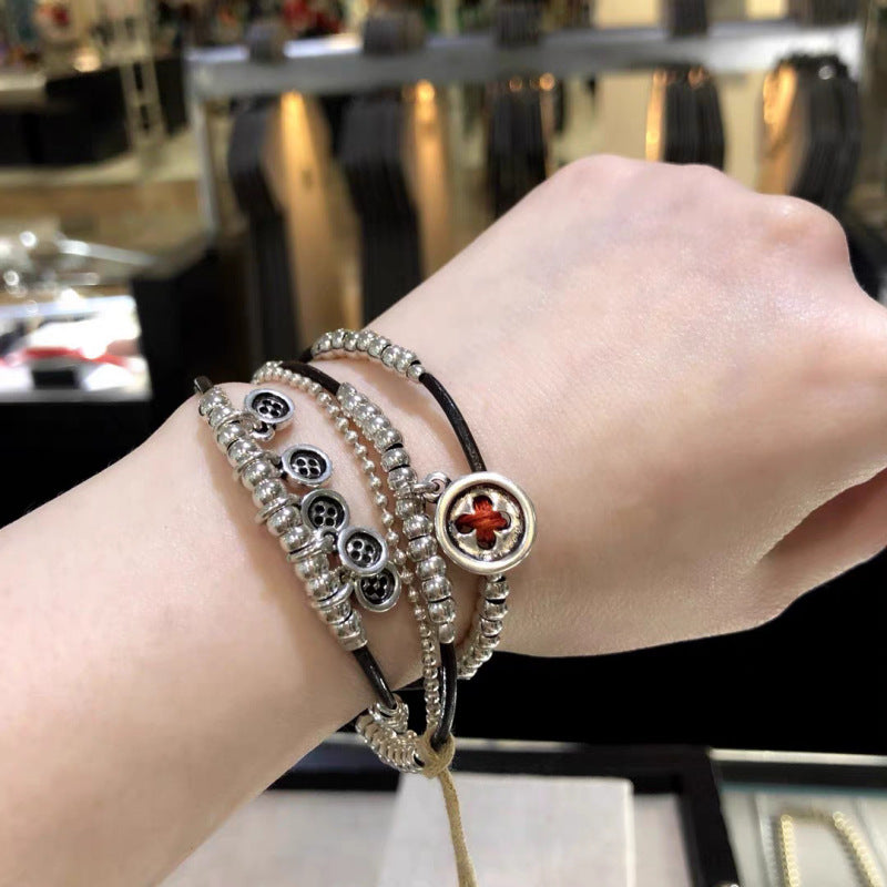 Silver bracelet on neutral background showing textured surface. Alt: “UNO de 50 Sterling Silver-Plated Bracelet – Textured Silver Cuff.”