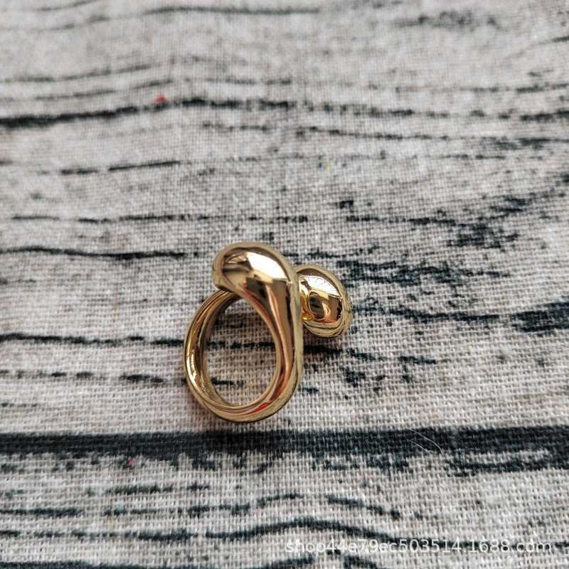 Open ring on neutral background showing sphere. Alt: “UNOde50 Open Ring with a Sphere – Silver Spherical Ring.”