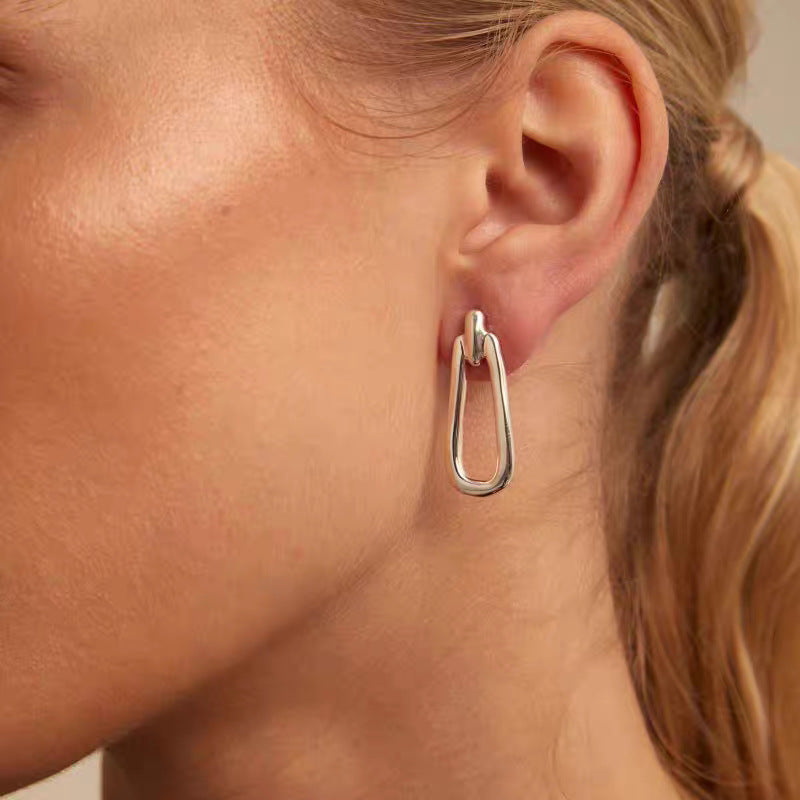 Earrings worn as intentional statement. Alt: “Wear Your Intentions: UNOde50 Prosperity.”