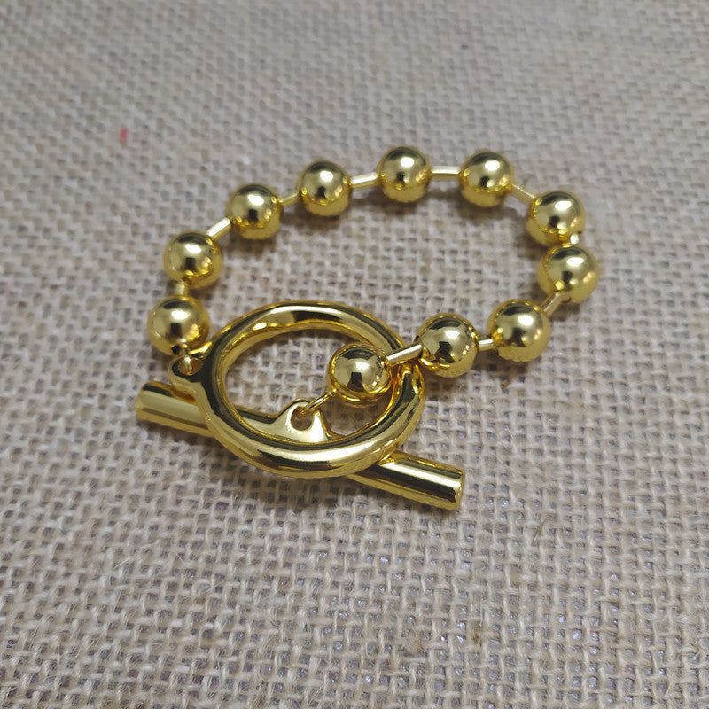 Gold snowflake bracelet on neutral or winter-inspired background. Alt: “UNOde50 Snowflake Bracelet Gold – Gold Snowflake Cuff.”