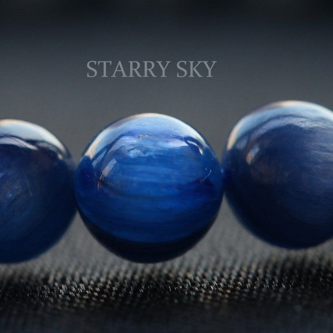 Three blue beads on a textured dark background with 'Starry Sky' text.