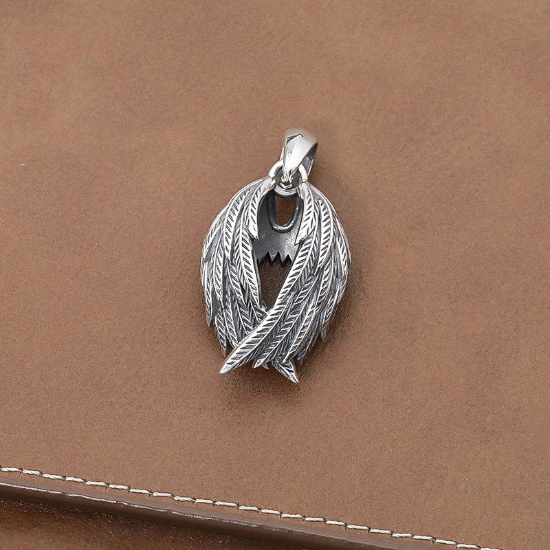 Silver pendant on a brown leather surface