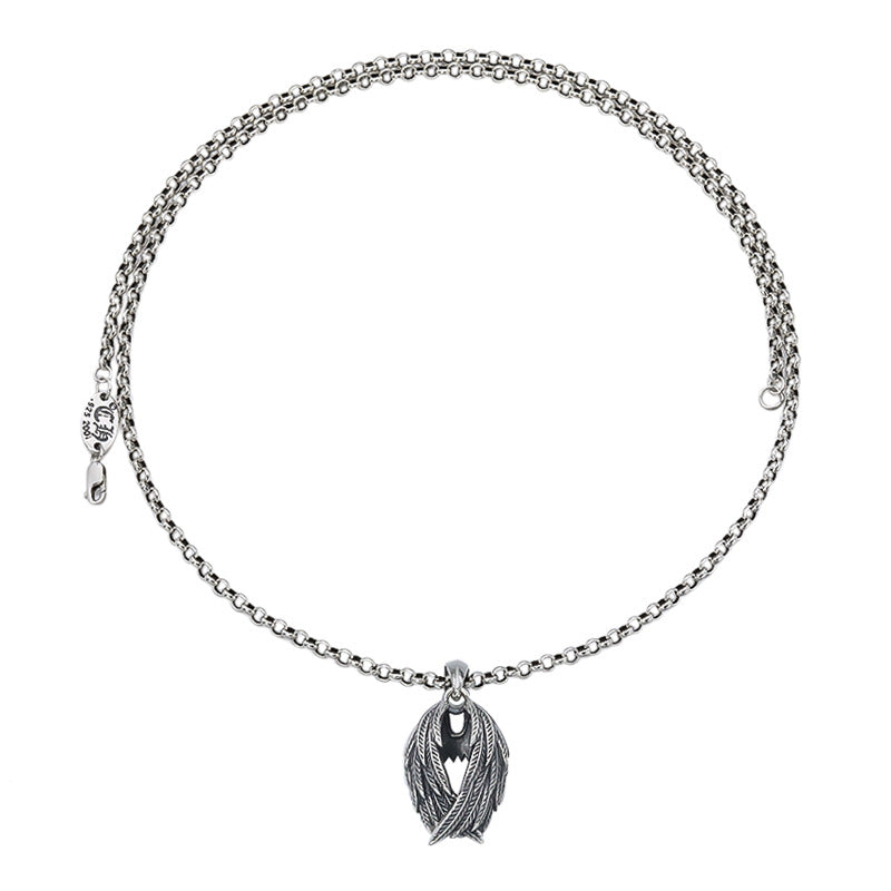 Silver chain necklace with a leaf-shaped pendant on a white background