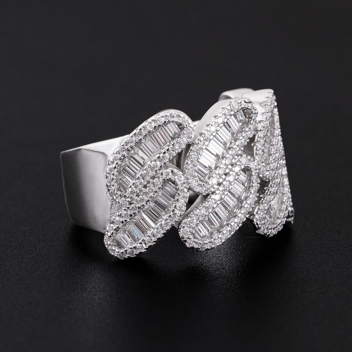 Close up view showing baguette moissanite channel setting on silver cuban link band