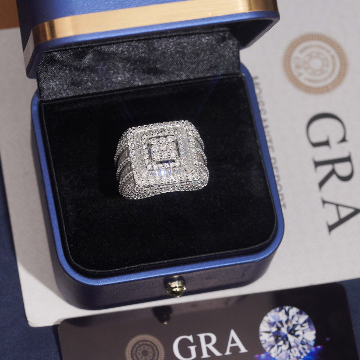 Iced out square tiered halo moissanite ring presented in dark navy velvet gift box with GRA certificate