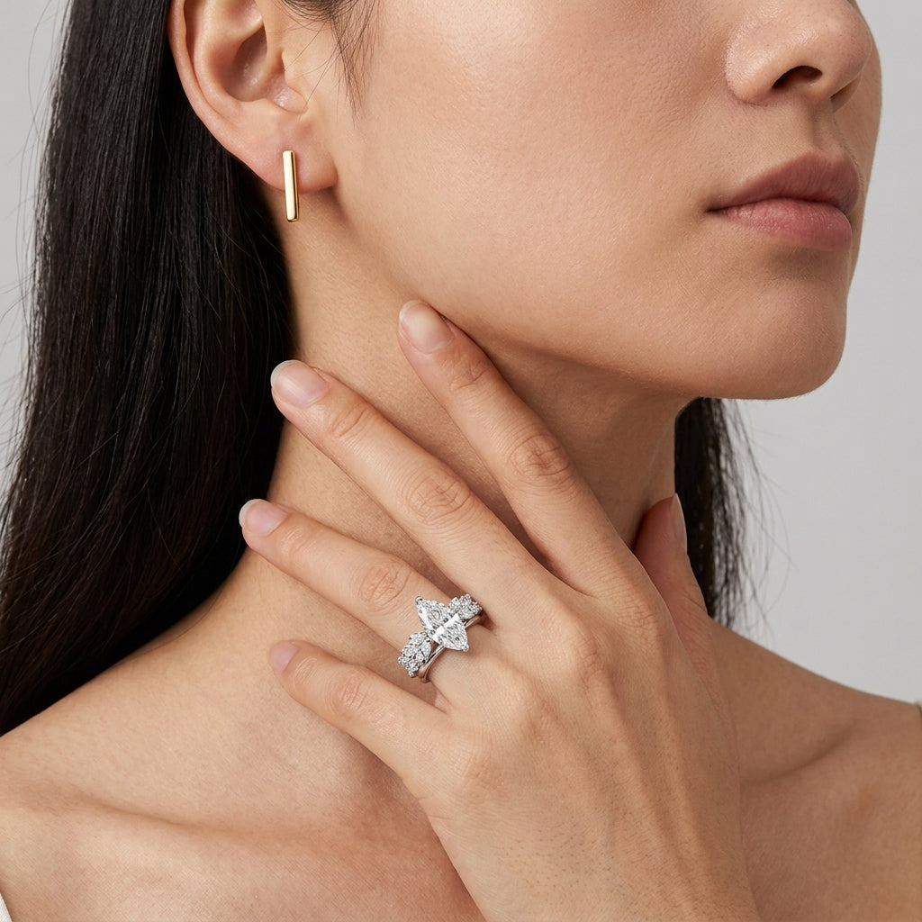 Close-up of a model wearing marquise cut moissanite three stone bridal set.