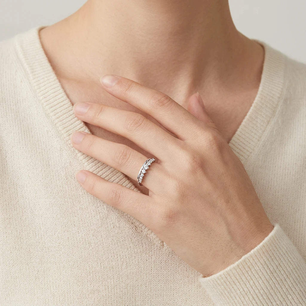 High-end fashion lookbook view of a model wearing a minimalist romantic vintage crown stackable jewelry ring with a soft sweater.