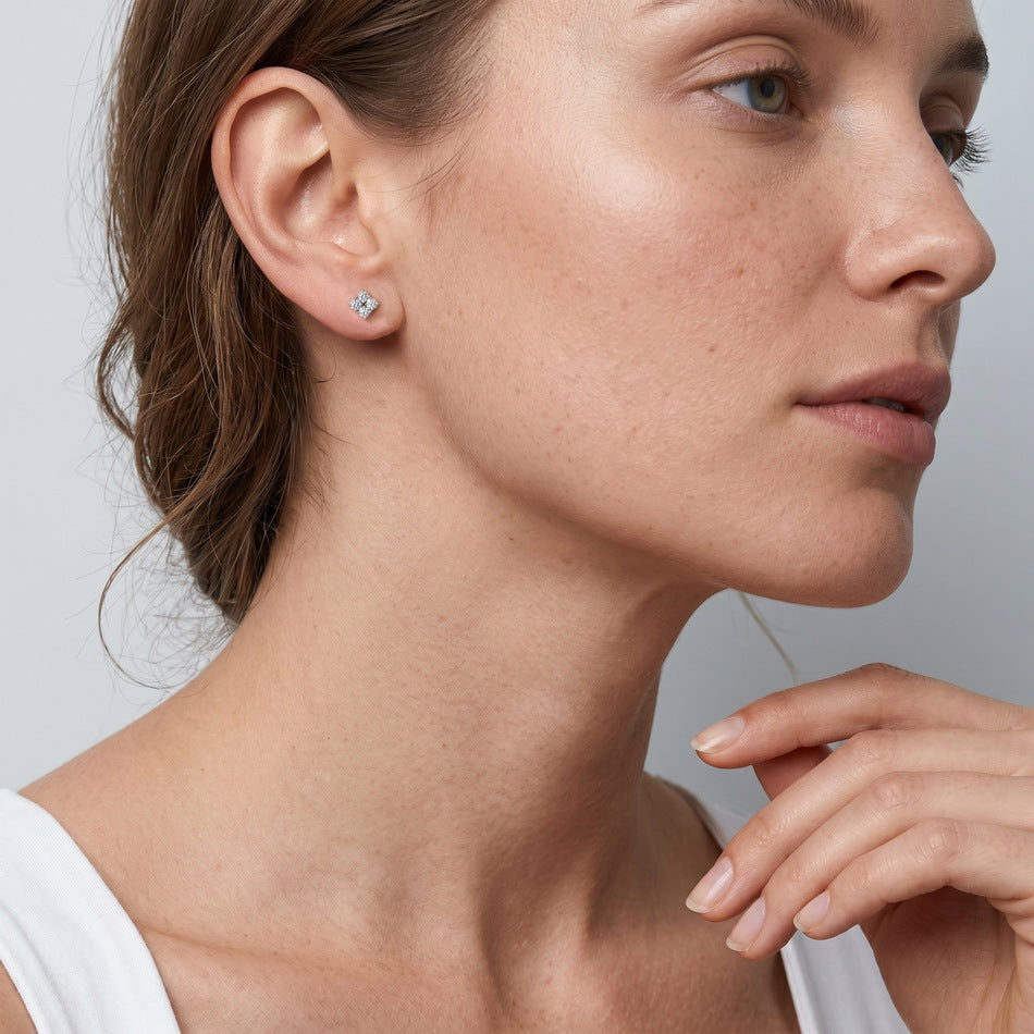Model wearing quad moissanite cluster stud earrings on earlobe.
