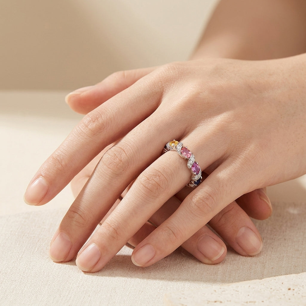 Full hand shot showing rainbow oval cut multi-color moissanite twisted band ring.